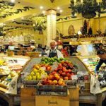 Food stall with fresh vegetables & fruit as well as cooked meals inside Harrods, Knightsbridge, London