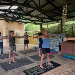 Pilates coach leonard Lubbe stands in front of the class he is coaching with his arms and legs stretched outwards