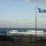 Southport beach with blue flag waving in the wind