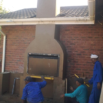 Workers busy plastering outdoor braai installed by NN Homes in Durban