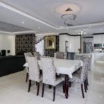 open plan diningroom, liitchen and lounge all in white