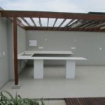 White tiled deck with kitchen cabinets and slatted roofing frame