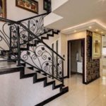 Staircase leading into entrance foyer in stylish home