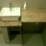 Single bathroom basin on marble top next to another marble top