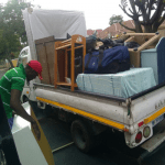 Open bed truck loaded with furniture