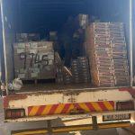 Open back of a truck shows cement piled in bags on wooden crates being delivered by _Sinayile Build House ta Easy Build Hardware in MaClear Elliot