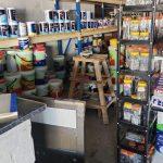 rows of shelves inside shop with very large variety of paint and a ladder at Maclear hardware suppliers shop