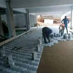 Grey and white paving being laid under roofing by Indlu Yegagu Iyanetha Primary Cooperative building construction Durban