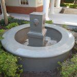 Garden water fountain in round concrete structure which has a shining surface as Bless had painted it