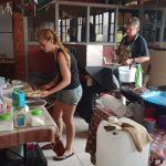 A young lady wearing denim shorts is packing pancakes onto a tray at the Family Fund Day event inside the Ifafa beach Hotel hall